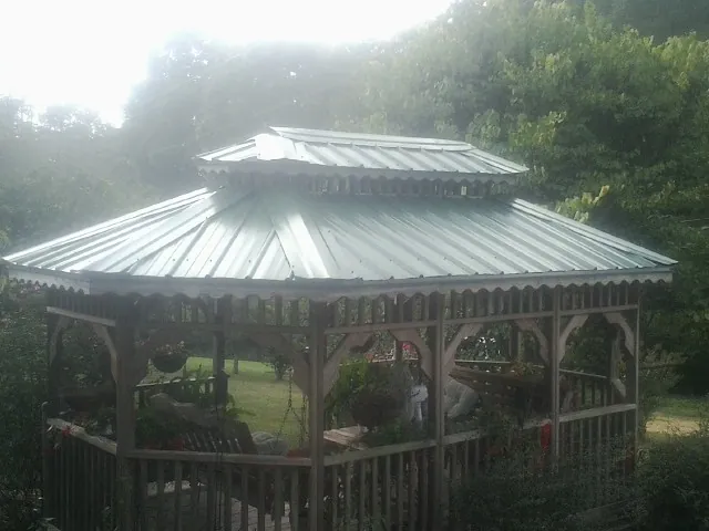Two tier green metal roof on a garden gazebo in Chester